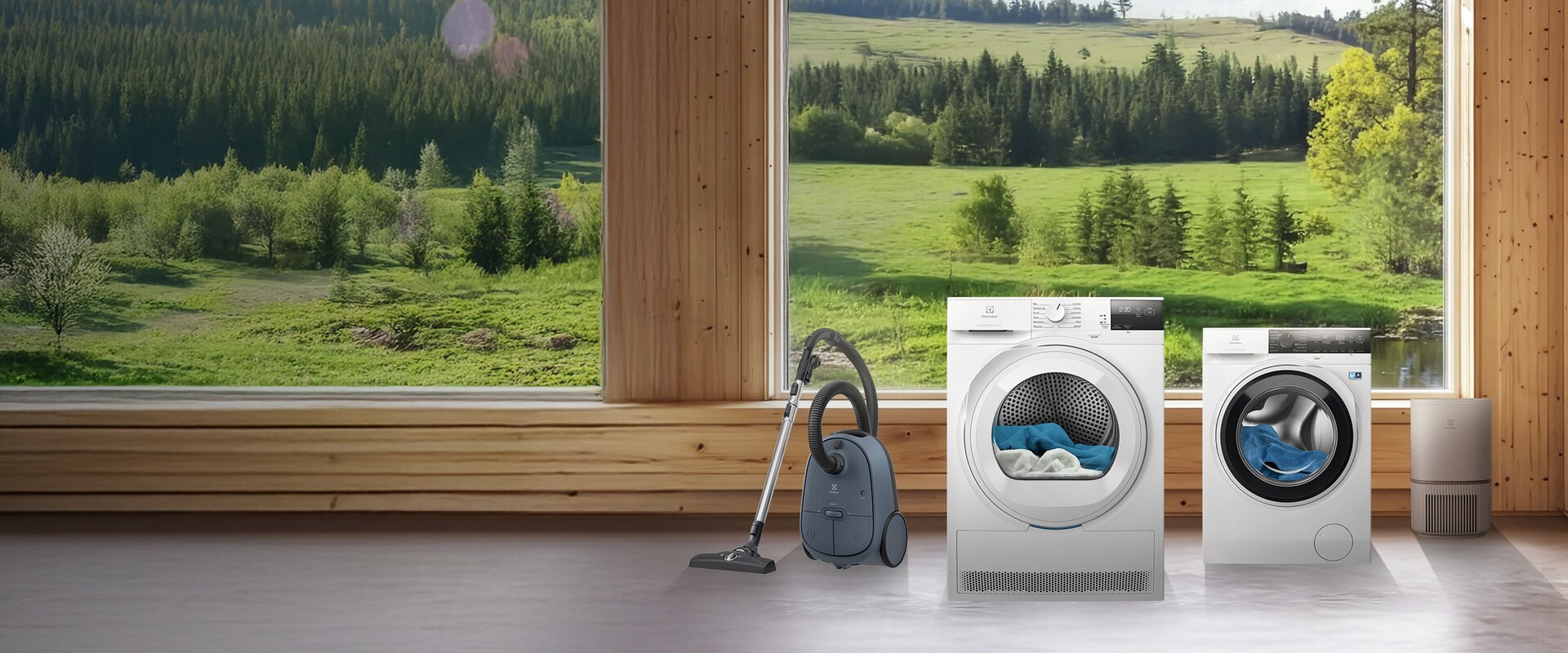 Electrolux buitiniais prietaisais, pro langą matomas pievų ir medžių fonas